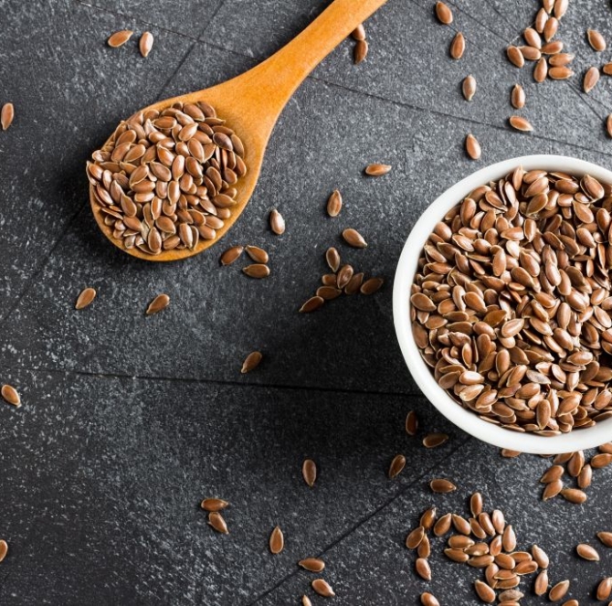 Flax seeds linseed superfood healthy organic food concept on dark background with copy space top view